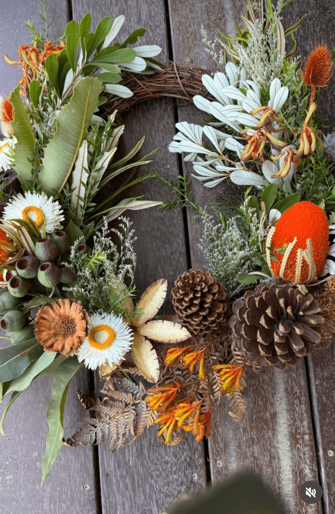 A Christmas wreath with native flowers, foliage and pine cones